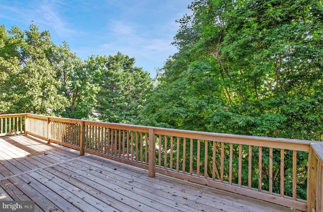 a view of balcony with wooden floor and fence
