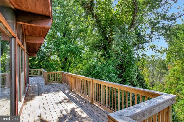 a view of balcony with deck and trees