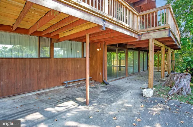 a view of a house with a yard and large trees