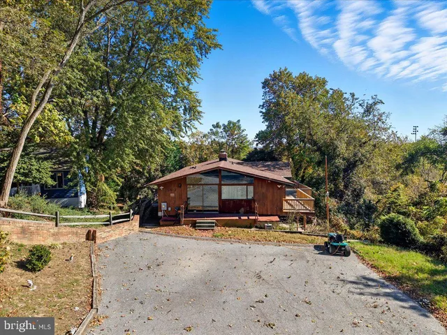 an aerial view of a house with a yard and garden
