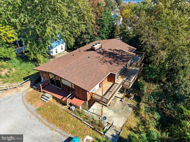 an aerial view of a house with a lake view