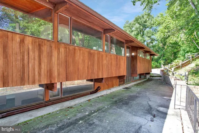 a backyard of a house with a garden and barbeque oven