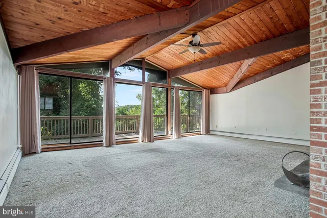 a view of an empty room with windows