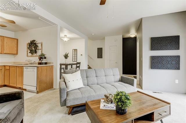 2002 Legacy Ridge View, Unit 112 Colorado Springs, CO 80910 - Photo 12 of 37 Bright living room featuring a gas fireplace, ceiling fan w/walk-out access to the patio.