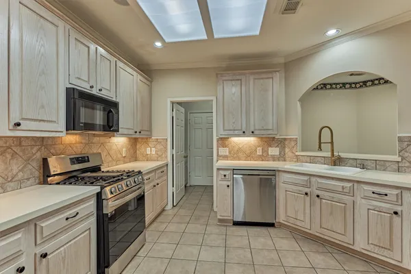 a view of an empty room with wooden floor and closet