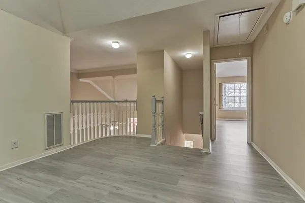 a view of backyard of house with wooden fence