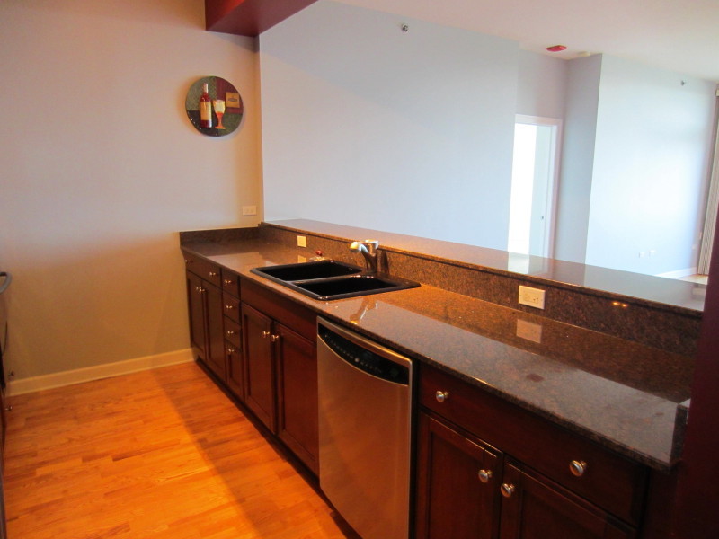 Undisclosed Address Chicago, IL 60605 - Photo 7 of 35 a kitchen with a sink and cabinets
