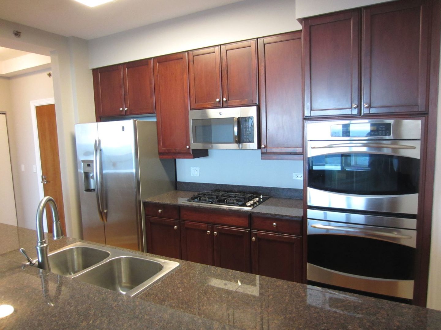 Undisclosed Address Chicago, IL 60605 - Photo 8 of 35 a kitchen with granite countertop a refrigerator stove and cabinets