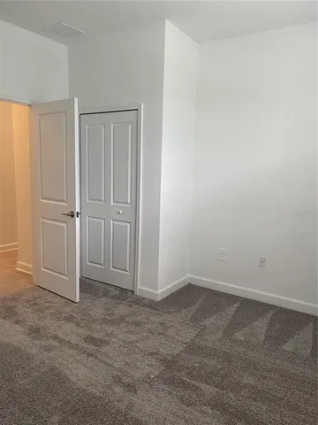 a bathroom with a granite countertop bathtub sink vanity mirror and toilet