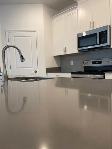 a kitchen with a microwave and a sink