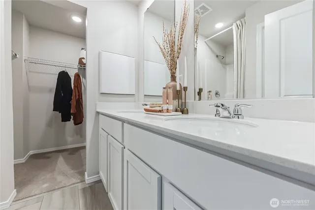 a vase of flowers sitting on a table in front of a house