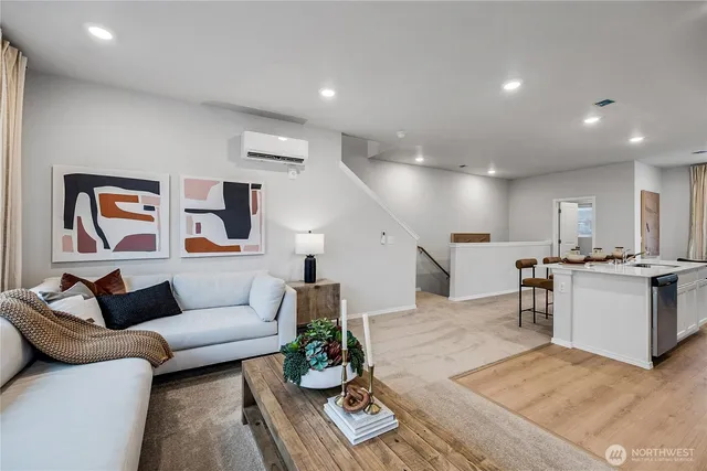 a living room with furniture and kitchen view
