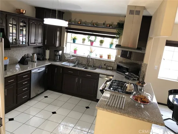 a kitchen with a sink appliances and cabinets
