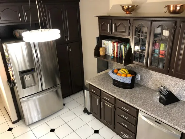 a kitchen with stainless steel appliances granite countertop a refrigerator and a sink