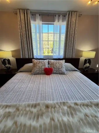 a bedroom with a large bed and a window