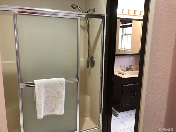 a bathroom with a shower and a sink
