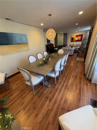 a view of a dining room with furniture wooden floor and chandelier