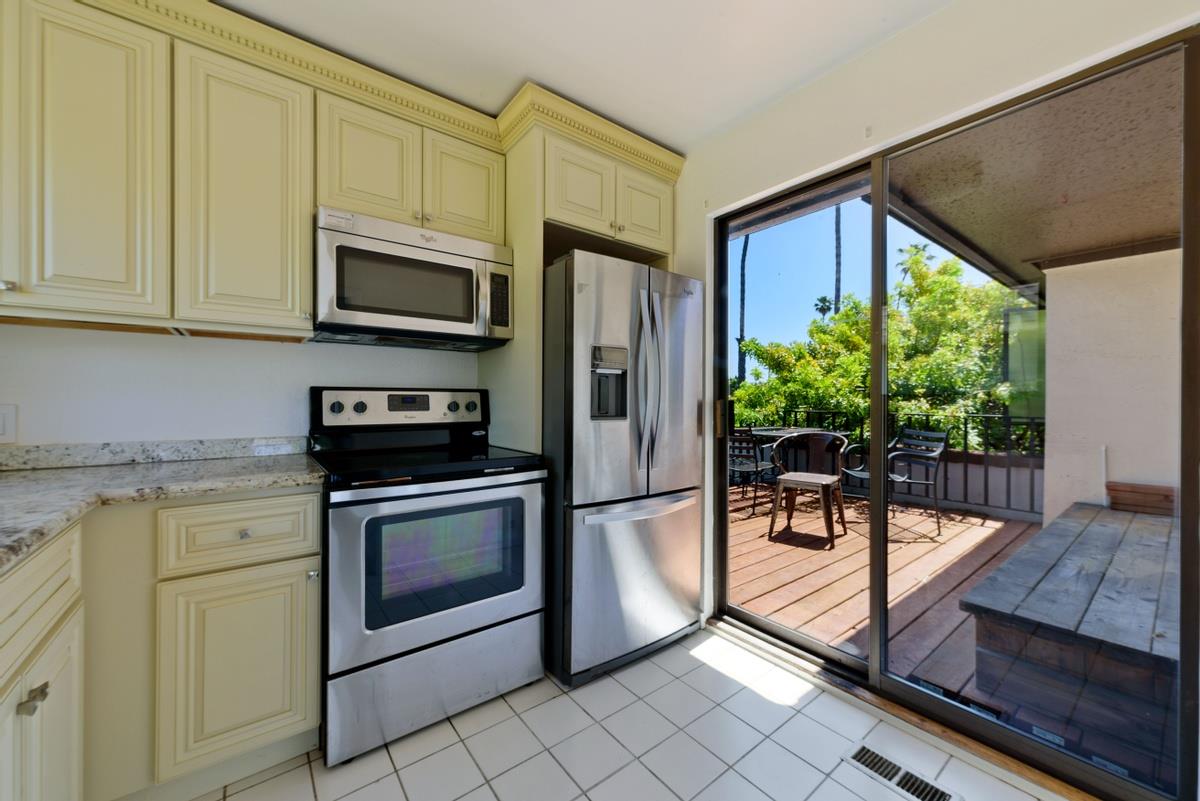 41 15th Avenue San Mateo, CA 94402 - Photo 6 of 11 a kitchen with stainless steel appliances granite countertop a stove a microwave and a refrigerator