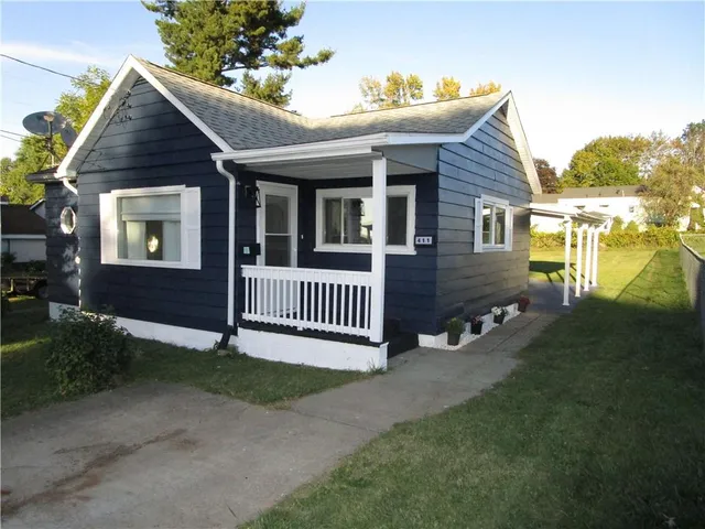 a view of a house with a yard and deck