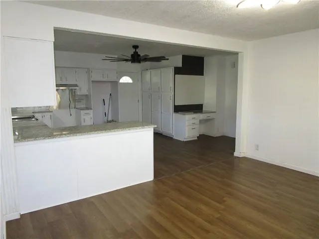 a view of kitchen with a sink and wooden floor