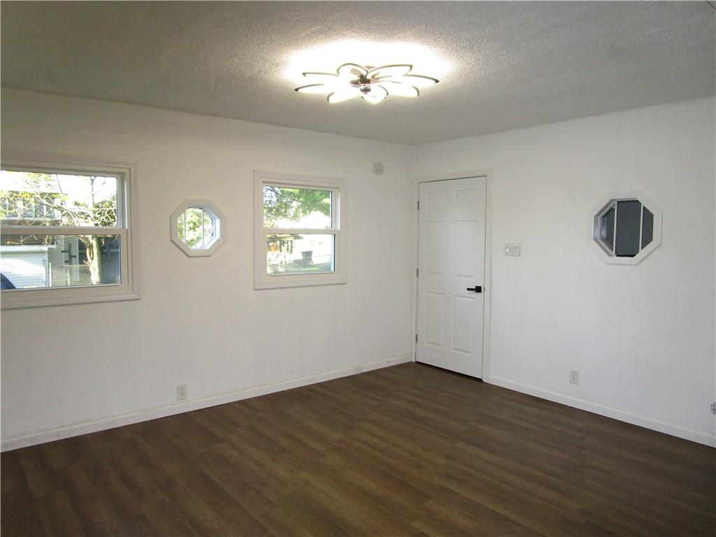 411 Emerson Avenue Farrell, PA 16121 - Photo 16 of 25 a view of empty room with wooden floor and fan