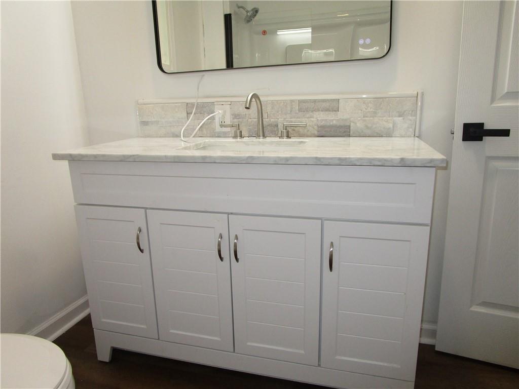 411 Emerson Avenue Farrell, PA 16121 - Photo 17 of 25 a bathroom with a sink and a mirror