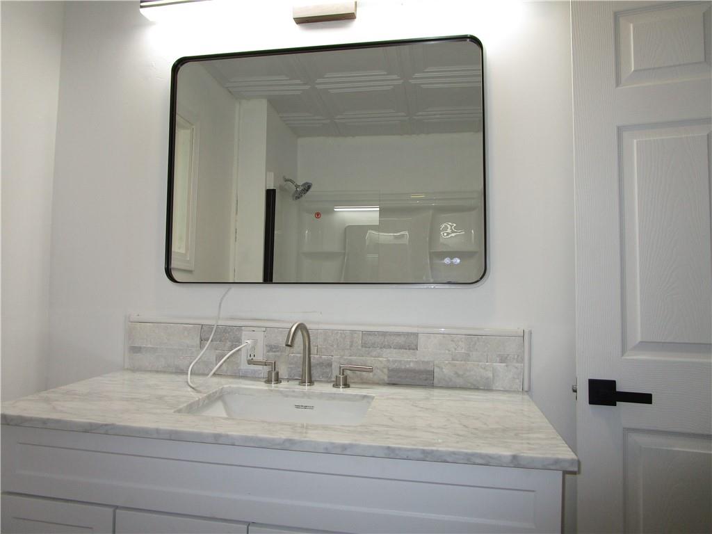 411 Emerson Avenue Farrell, PA 16121 - Photo 19 of 25 a bathroom with vanity and mirror