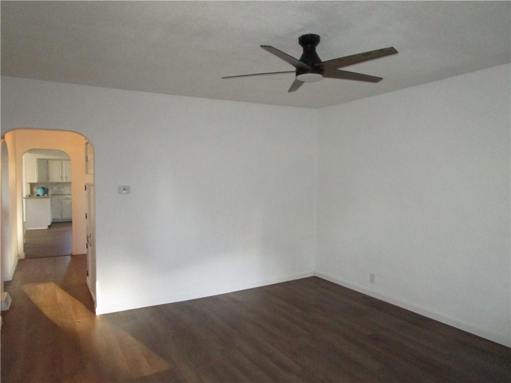 411 Emerson Avenue Farrell, PA 16121 - Photo 9 of 25 wooden floor in an empty room with a window