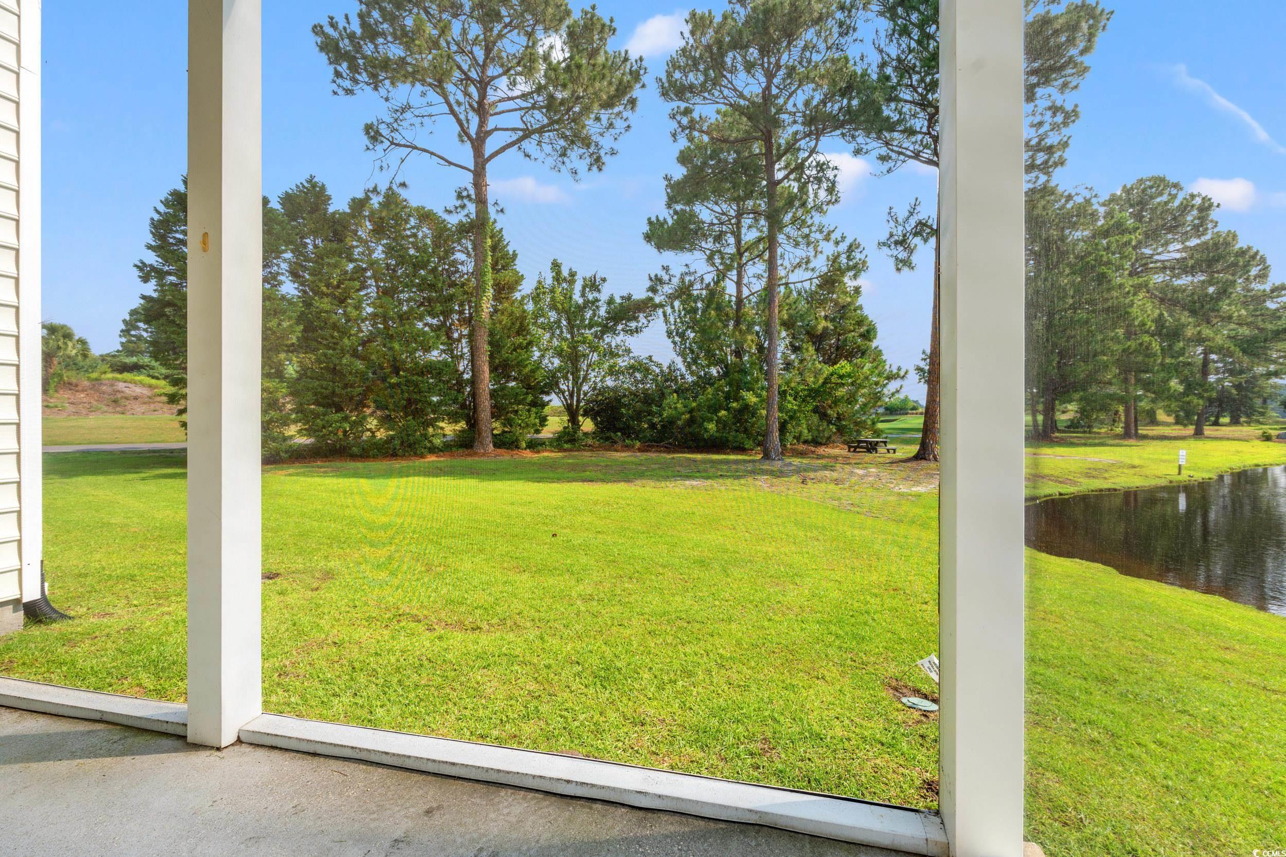 6000 Windsor Green Way, Unit 104 Myrtle Beach, SC 29579 - Photo 8 of 34 View of green lawn featuring a water view