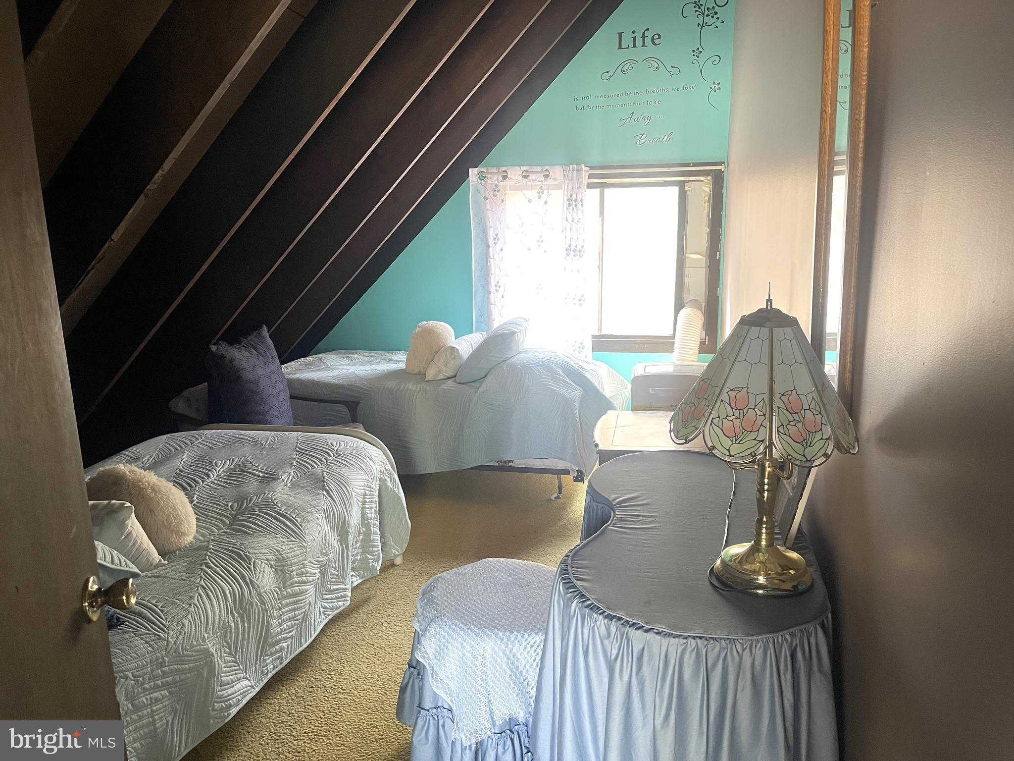 272 North Glebe Road Montross, VA 22520 - Photo 19 of 20 a bed sitting in a bedroom next to a window