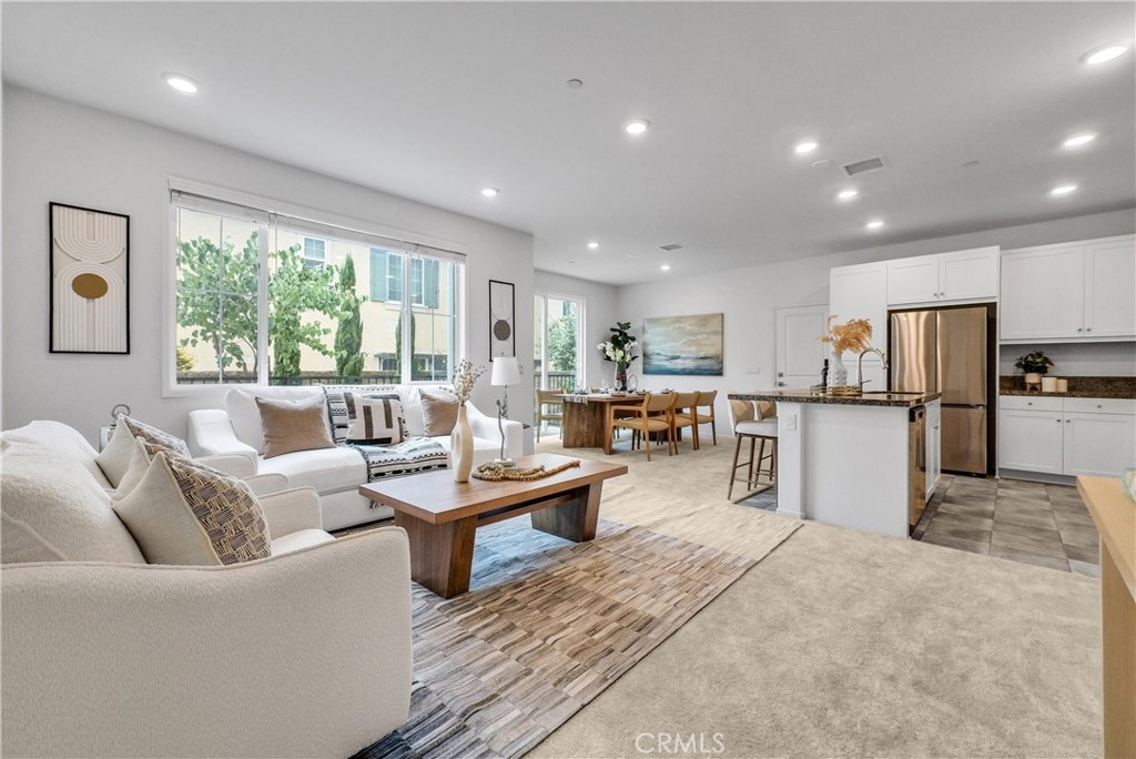 5584 Kate Way, Unit 10 Fontana, CA 92336 - Photo 1 of 42 a living room with furniture a refrigerator and kitchen view