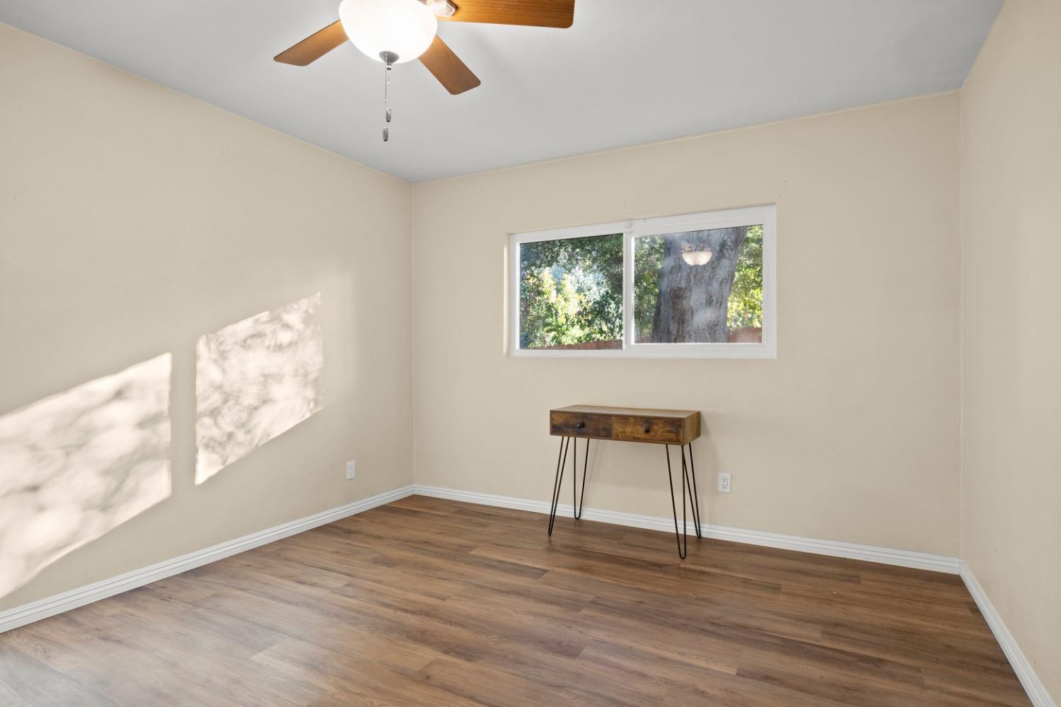 385 Burnham Road Oak View, CA 93022 - Photo 12 of 25 a view of an empty room with wooden floor and a window