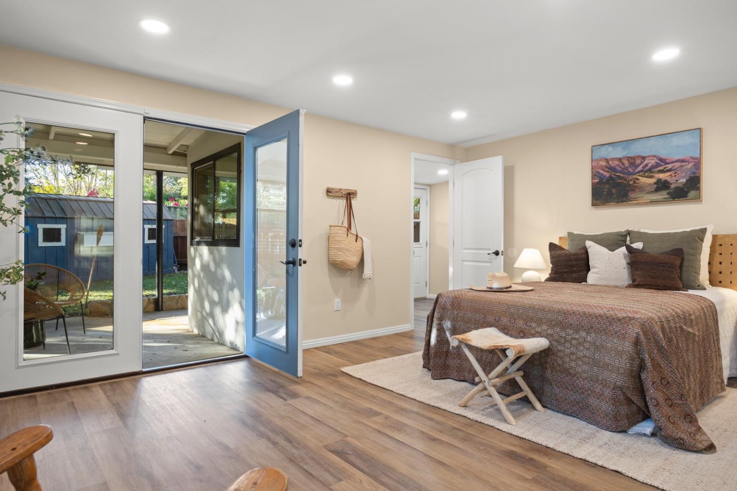 385 Burnham Road Oak View, CA 93022 - Photo 8 of 25 a spacious bedroom with a bed and glass door
