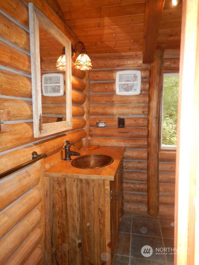 51614 South Riverside Road Gold Bar, WA 98251 - Photo 35 of 37 a bathroom with a sink and a mirror