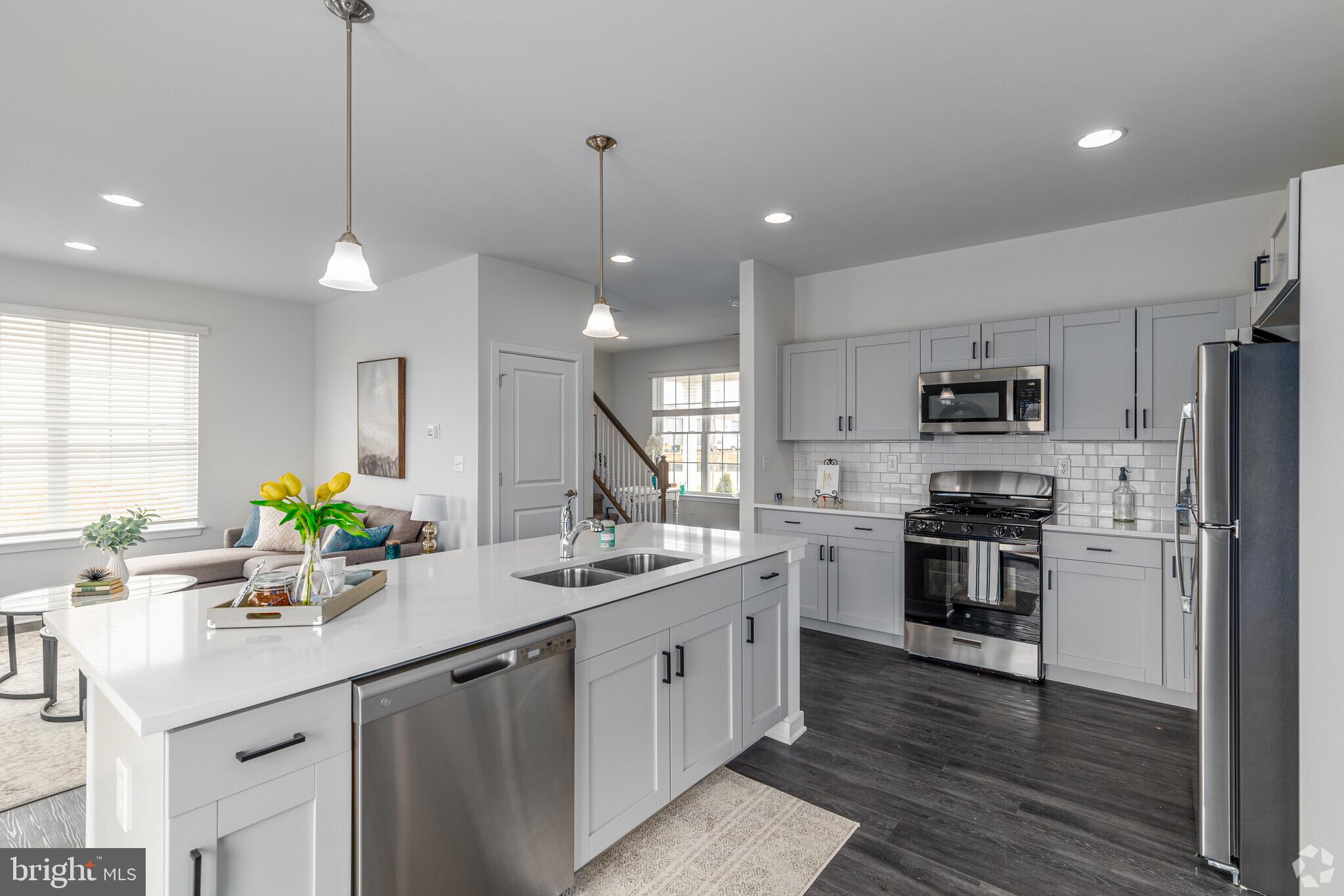 541 Ruth Way Dover, DE 19904 - Photo 3 of 10 a kitchen with stainless steel appliances kitchen island a sink refrigerator and microwave