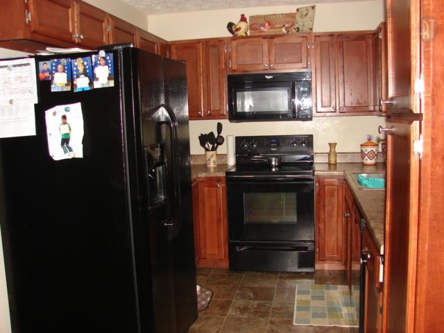 1200 Mt Vernon Road Bethpage, TN 37022 - Photo 1 of 12 a kitchen with a refrigerator stove and microwave
