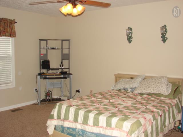 1200 Mt Vernon Road Bethpage, TN 37022 - Photo 7 of 12 a bedroom with a bed and a chandelier