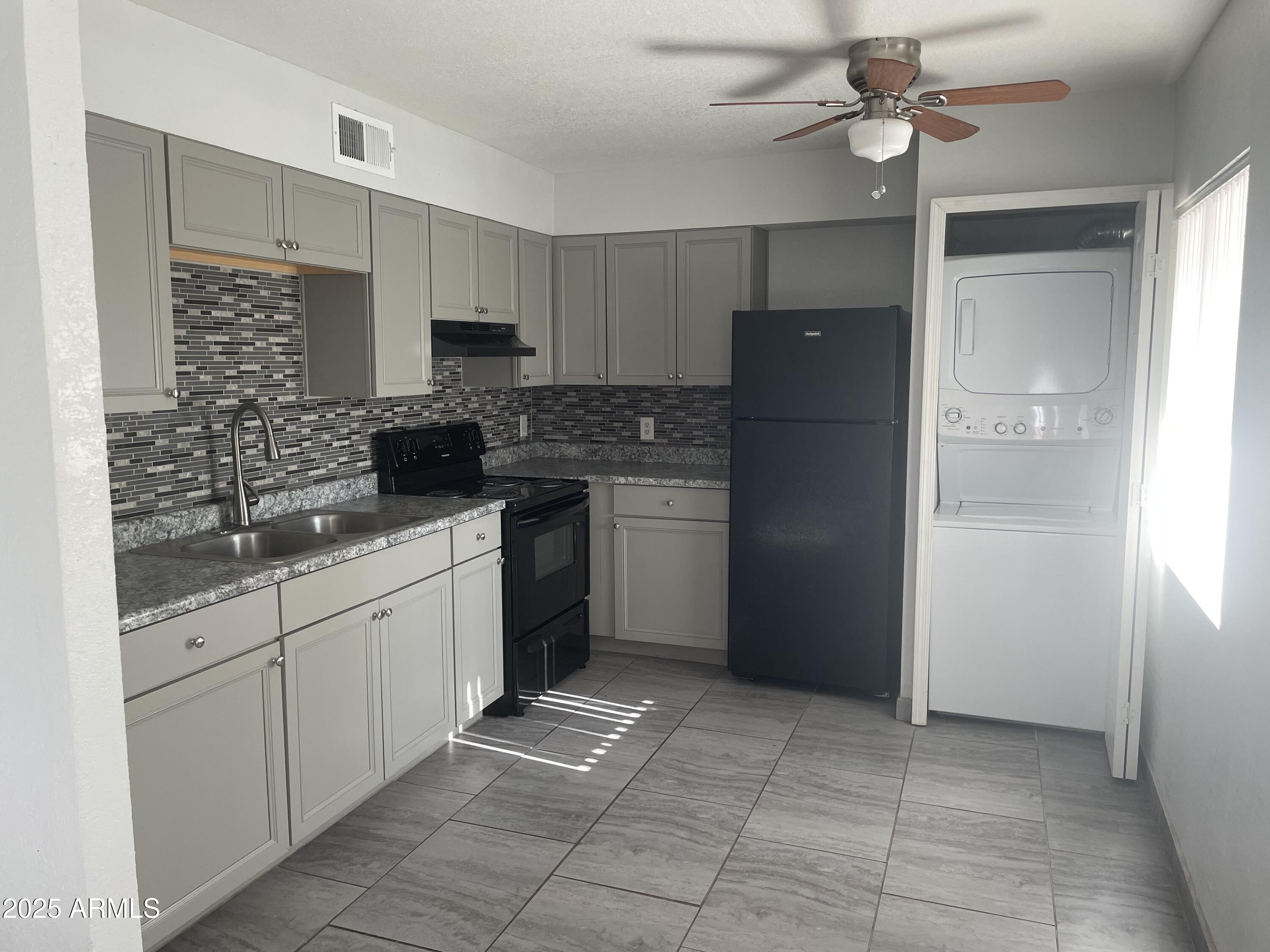 a kitchen with stainless steel appliances granite countertop a refrigerator and a sink