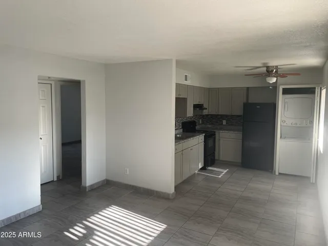 a kitchen with a refrigerator and a sink