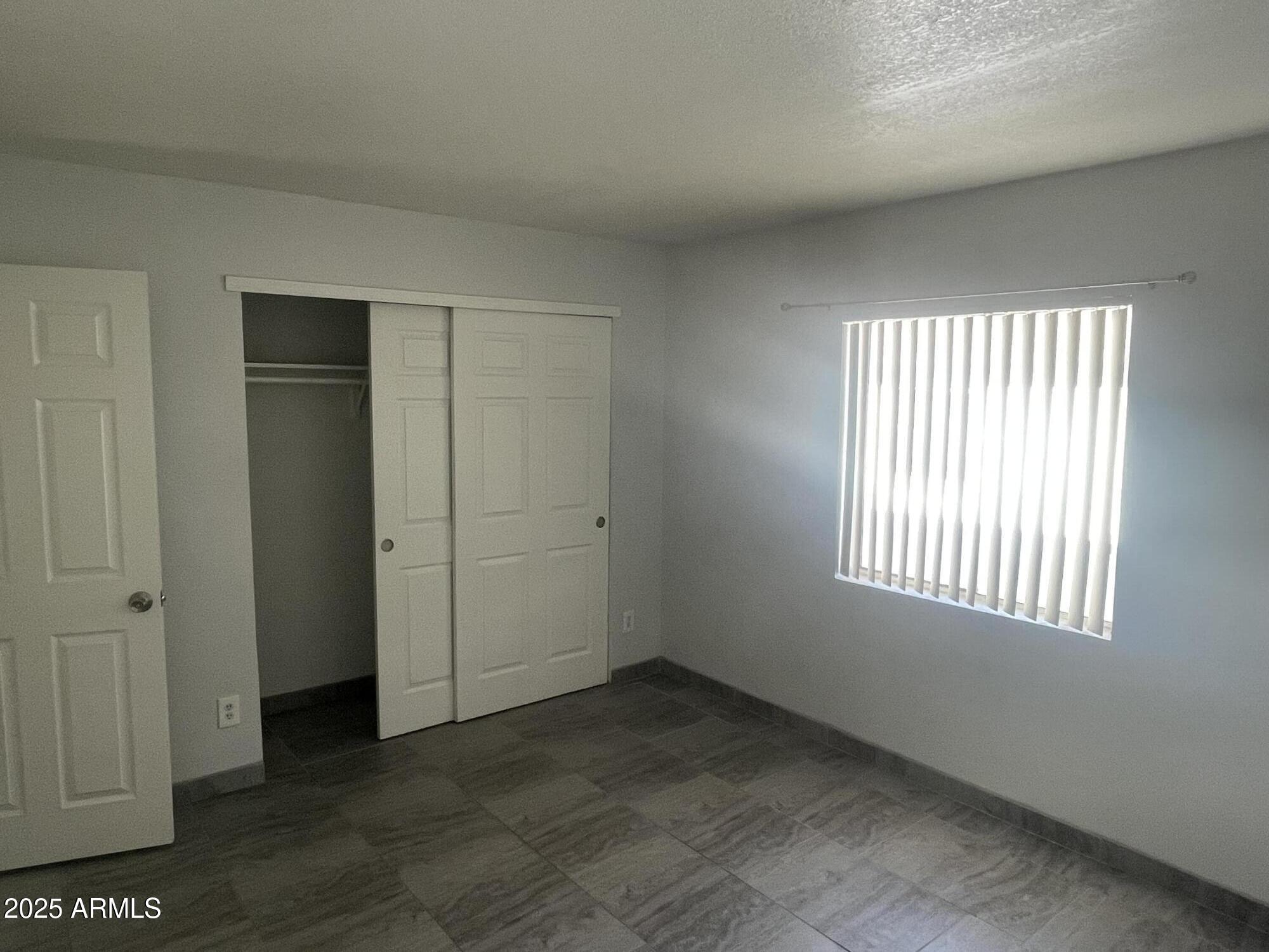1222 East Mountain View Road, Unit 208 Phoenix, AZ 85020 - Photo 10 of 24 an empty room with windows