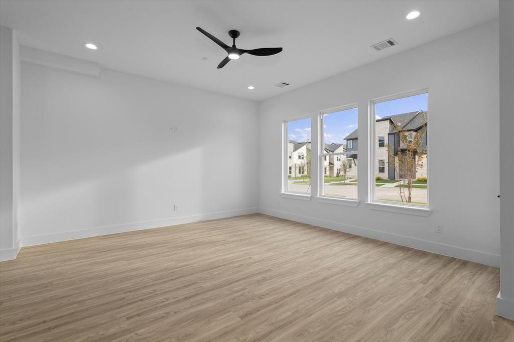 8918 Lowell Street Rowlett, TX 75089 - Photo 14 of 30 a view of an empty room with a window and wooden floor