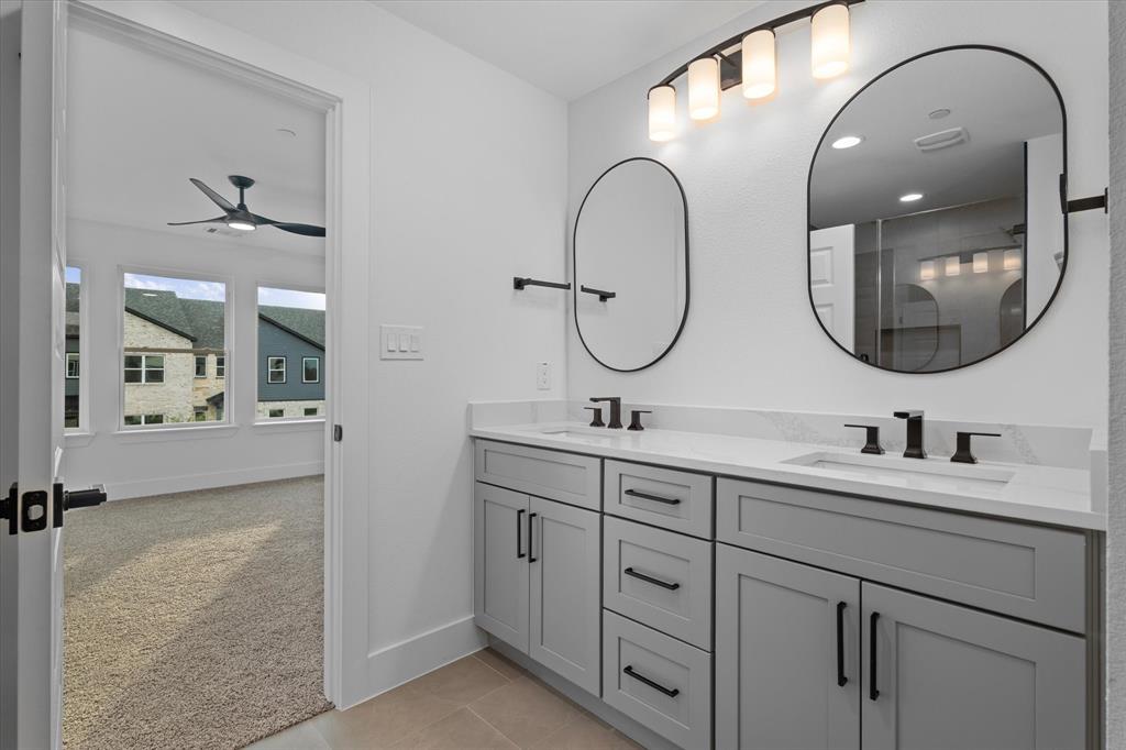8918 Lowell Street Rowlett, TX 75089 - Photo 25 of 30 a bathroom with a double vanity sink and a mirror