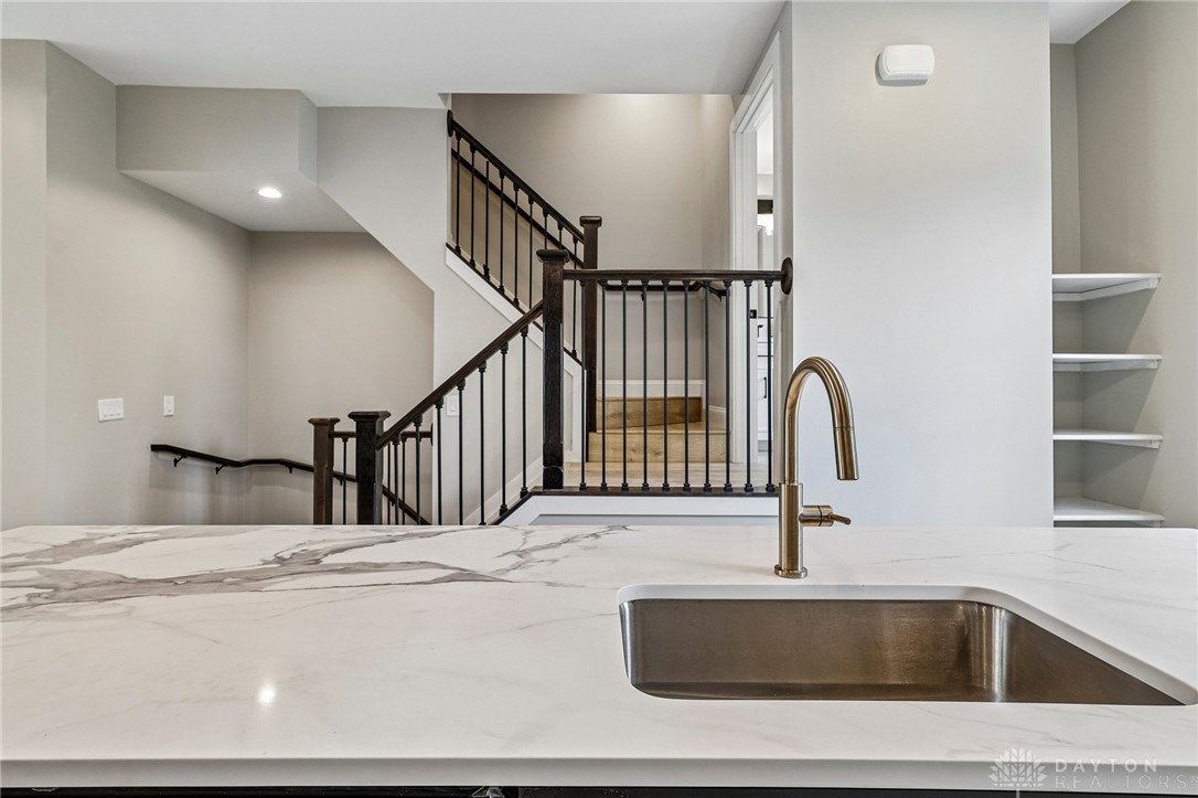 3906 Edwards Road, Unit C Cincinnati, OH 45209 - Photo 15 of 46 This modern kitchen island offers sleek design and a view of the home's elegant staircase.