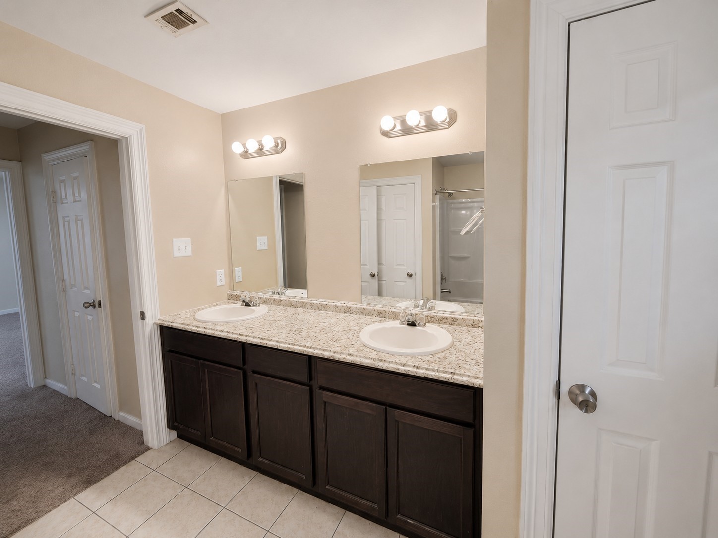 12926 Abalone Way Houston, TX 77044 - Photo 7 of 15 a bathroom with a double vanity sink and a mirror