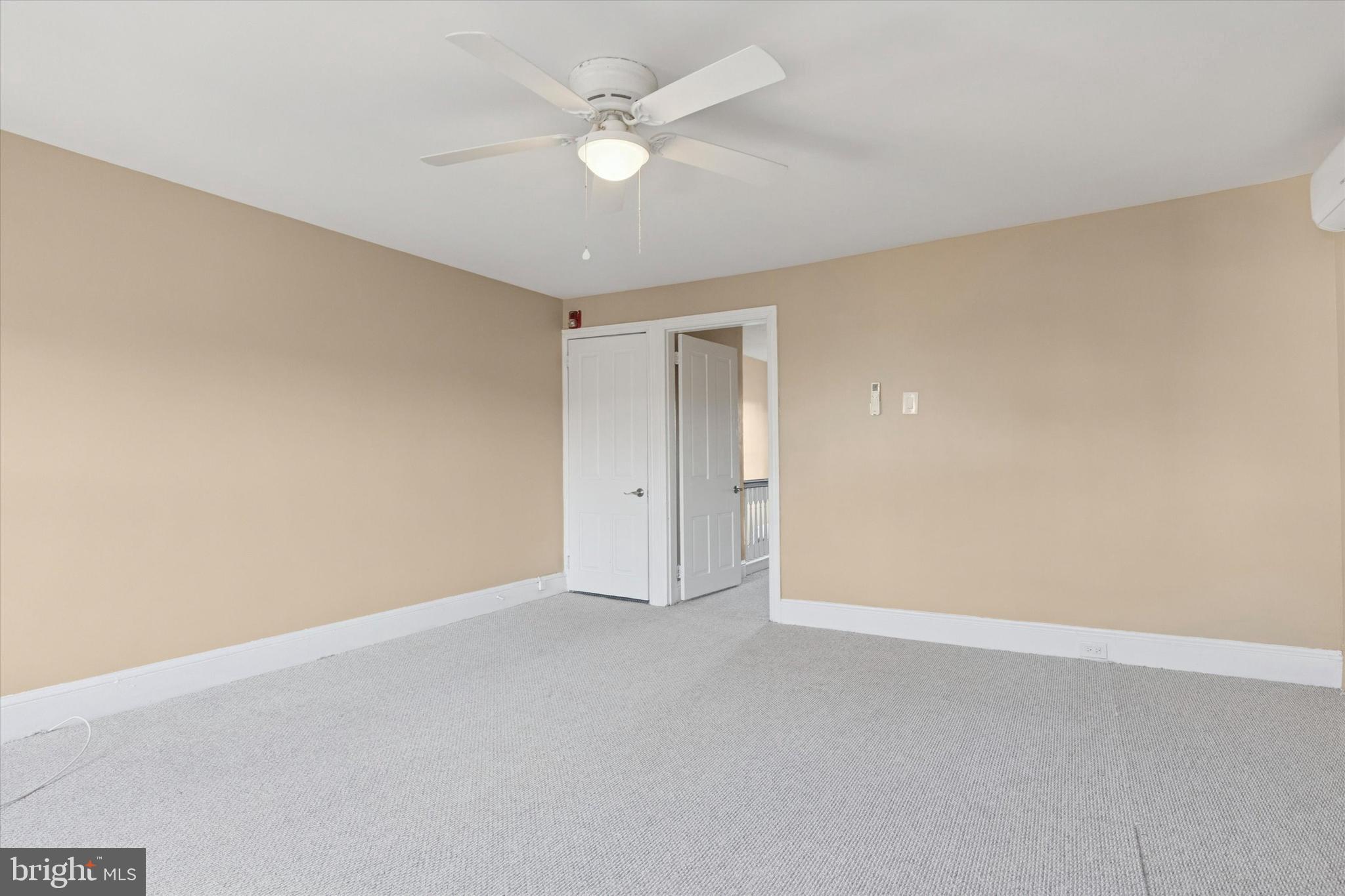 206 Ripka Street, Unit 2 Philadelphia, PA 19127 - Photo 14 of 15 an empty room with a ceiling fan and a window
