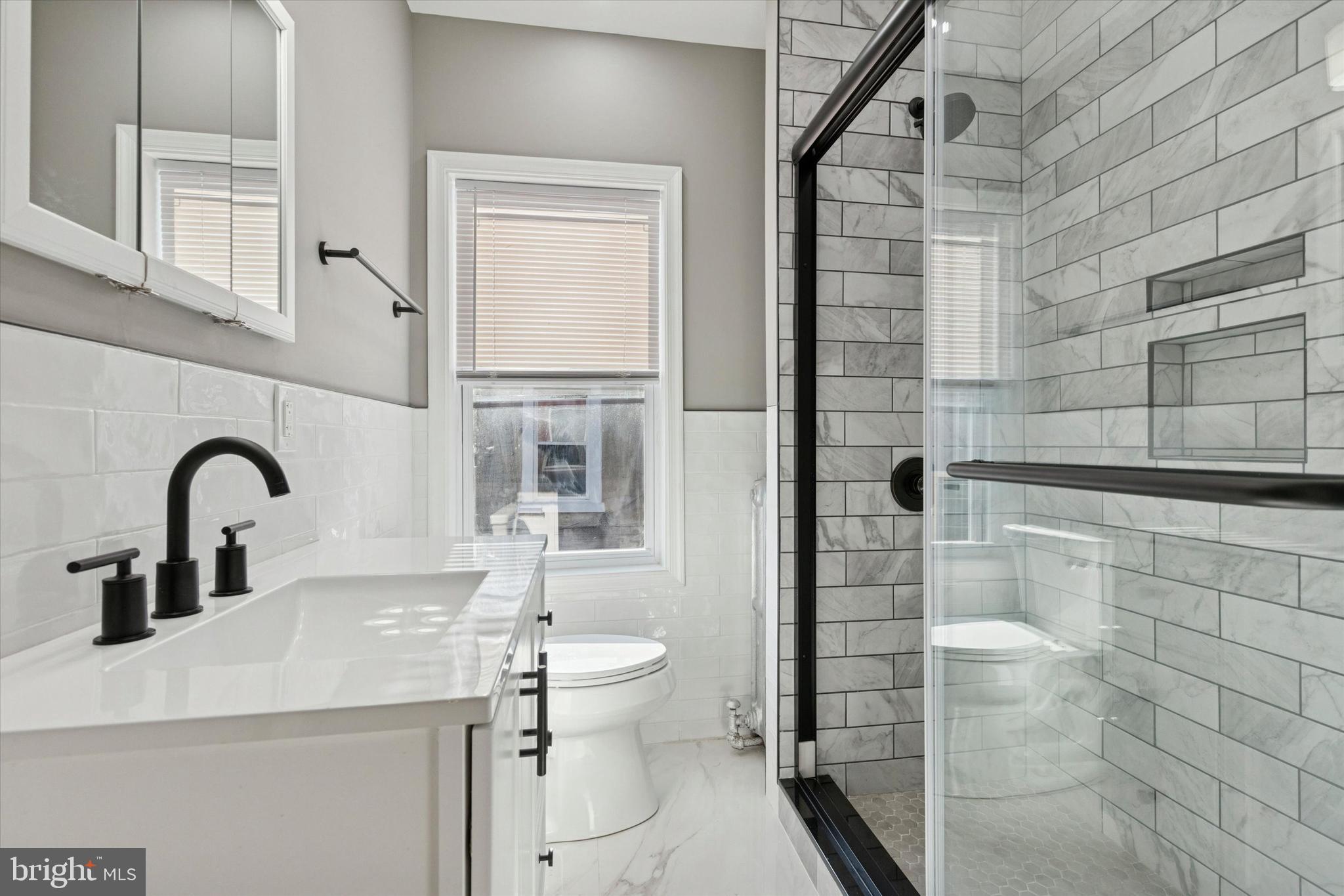 206 Ripka Street, Unit 2 Philadelphia, PA 19127 - Photo 6 of 15 a bathroom with a sink a toilet and shower