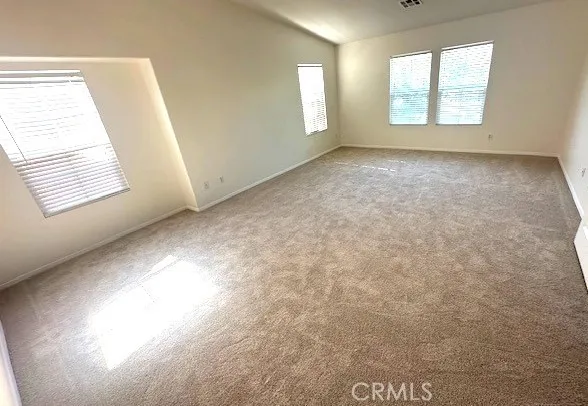 a view of a hallway with a glass door and couch