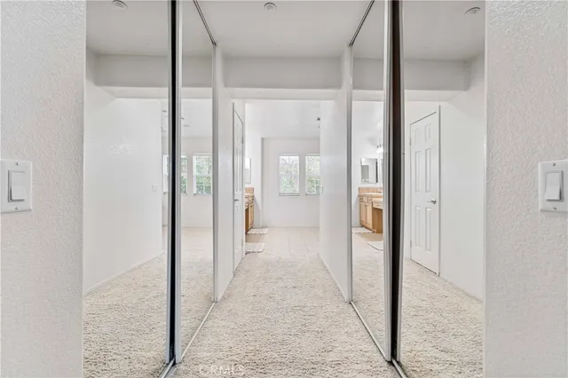 a spacious bathroom with a granite countertop sink a mirror and a bathtub