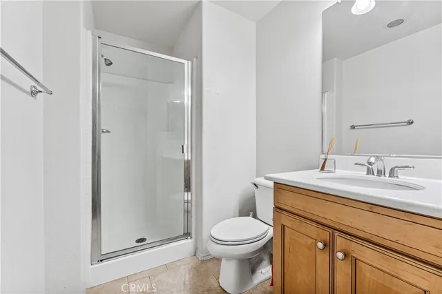 a bathroom with a granite countertop toilet sink and a mirror