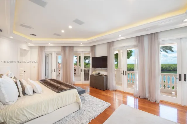 a bedroom with a balcony a bed and a television